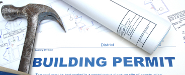 Hammer and blueprint with the words Building Permit placed as an overlay.